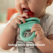 Baby using Frida baby push pop feeder with turquoise handle and mesh pouch