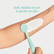 Silicone diaper cream booty brush applying cream on arm, mint teal soft bristles