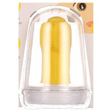 Yellow finger toothbrush under clear dome cover