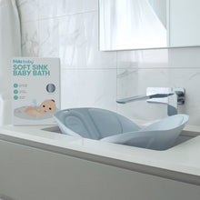 Soft sink baby bath tub placed in bathroom sink, light gray basin