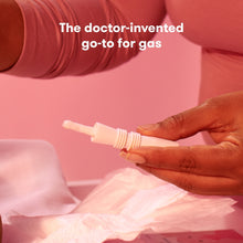 Caregiver holding a white windi tube to use for infant gas relief