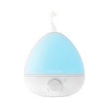 White humidifier with blue nightlight glow and visible mist plume