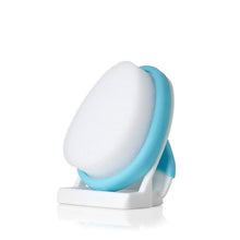 Oval foam scalp sponge on small white stand with blue rim