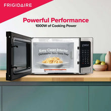 Stainless steel countertop microwave open door showing empty glass interior tray