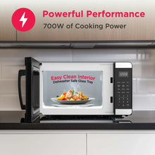 Countertop microwave oven with door open, showing interior cavity and control panel