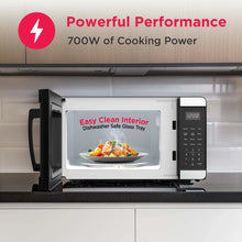 Frigidaire countertop microwave oven with door open, showing glass turntable tray inside
