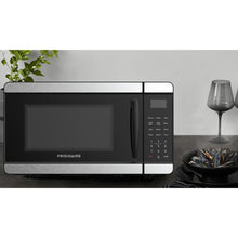 Frigidaire countertop microwave oven, black front with handle and control keypad