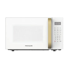Countertop microwave front with gold handle strip and illuminated clock display