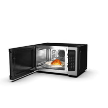 Frigidaire countertop microwave oven with open door and turntable, black exterior