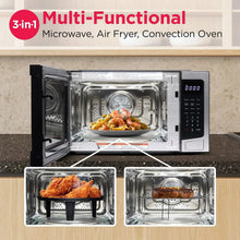 Frigidaire countertop microwave oven with open door and air-fry accessories, stainless and black