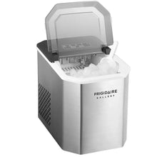 Stainless steel ice maker with open lid and visible ice cubes in bin