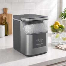 Frigidaire Gallery nugget ice maker on countertop with clear bin of nugget ice