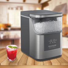 Frigidaire Gallery nugget ice maker on wood table with ice bin filled