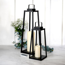 Black metal LED lantern with frosted pillar candle, remote control visible