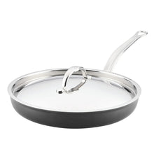 Covered nonstick skillet with lid and stainless loop handle; dark interior and side grip