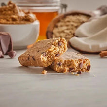 Protein bars, peanut butter coconut chocolate, two bars with crunchy bits visible
