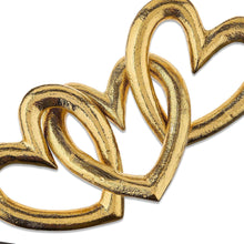 Gold linked heart chain decoration, close-up of overlapping heart loops
