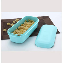 GE countertop microwave oven with turquoise containers holding pasta shells on tray