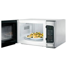 GE countertop microwave oven with open door showing cooking chamber and control keypad