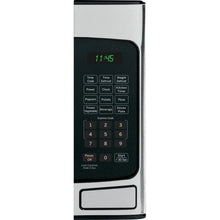 GE countertop microwave oven control panel with clock display and number keypad