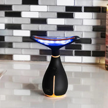 Black face and neck massage device with blue light display
