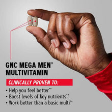 GNC Mega Men multivitamin blister pack in hand, red sleeve