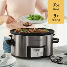 Oval stainless steel slow cooker with front control panel and carry handles