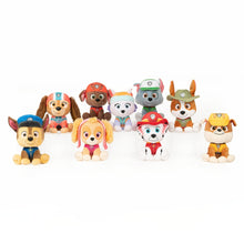 Assorted small plush dog toys in uniforms, lined up together