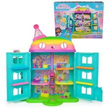Celebration dollhouse toy with open teal rooms, rainbow roof, and included figures