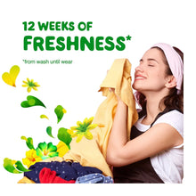 Gain Fireworks scent booster beads with a woman holding fresh folded linens