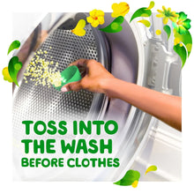 Gain Fireworks scent booster beads being tossed into a washing machine drum by hand