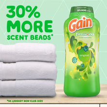 Gain Fireworks scent booster beads bottle with folded white towels, 30% more