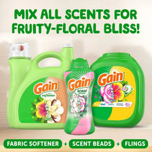 Assorted Gain scent booster bottles lineup in green, including a small and two large bottles