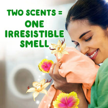 Woman smiling while holding a towel with vanilla and hibiscus flower illustrations