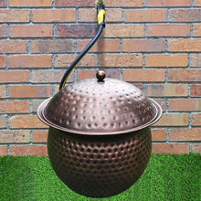 Dark copper hammered hose storage pot with domed lid and hose spout