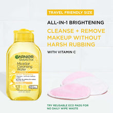 Micellar cleansing water travel bottle with two pink reusable cleansing pads