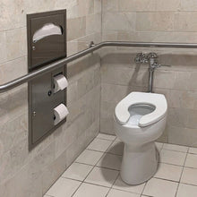 Toilet with a roll of white bath tissue on a wall-mounted holder