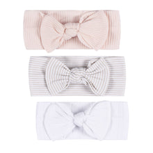 Pink ribbed baby headband with large bow at center