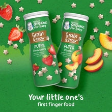 Organic grain & grow puff cereal canisters, two bottles labeled Peach and Strawberry