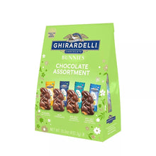 Chocolate bunny assortment bag, green, showing label and multiple boxed chocolate bunnies.