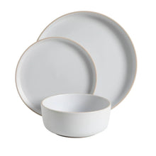 Stacked white coupe bowls and plates, minimalist dinnerware