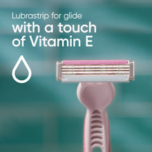 Three-blade razor head on a pink handle, with lubricant strip