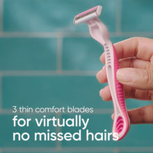 Disposable women's razor with pink handle and three comfort blades