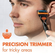 Manual razor with black handle and blue/orange 5-blade head, held for trimming