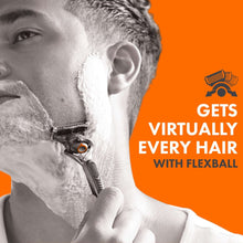 Men’s shaving razor held near a man’s cheek and jawline, cartridge visible