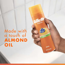 Orange Gillette Fusion sensitive shave gel can in hand with blue almond-oil icon