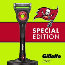 Men's Gillette Labs razor handle with red shaving cartridge, front view on stand.