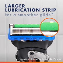 Razor blade cartridge with visible green lubrication strip in blue frame.