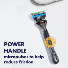 Power razor handle with blue blade cartridge, black handle with glowing ring.