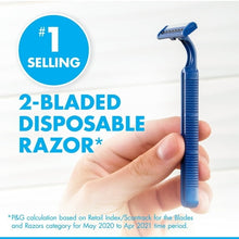 Men's 2-bladed disposable razor with blue handle held in a hand
